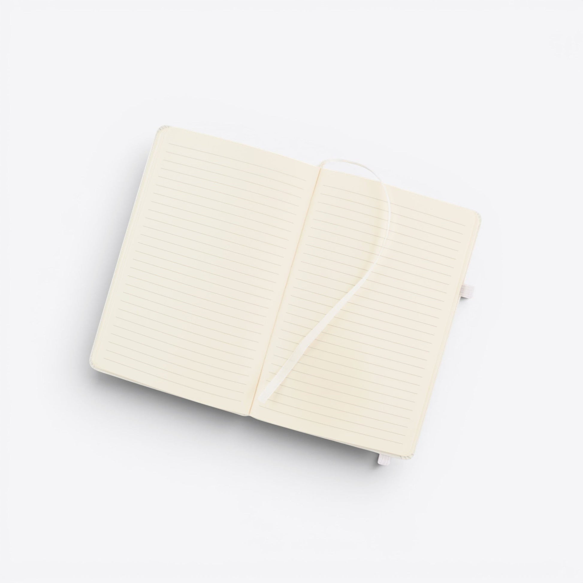 TODAY MERCH cream-colored lined notebook with integrated pen holder and ribbon bookmark, open to show blank pages.