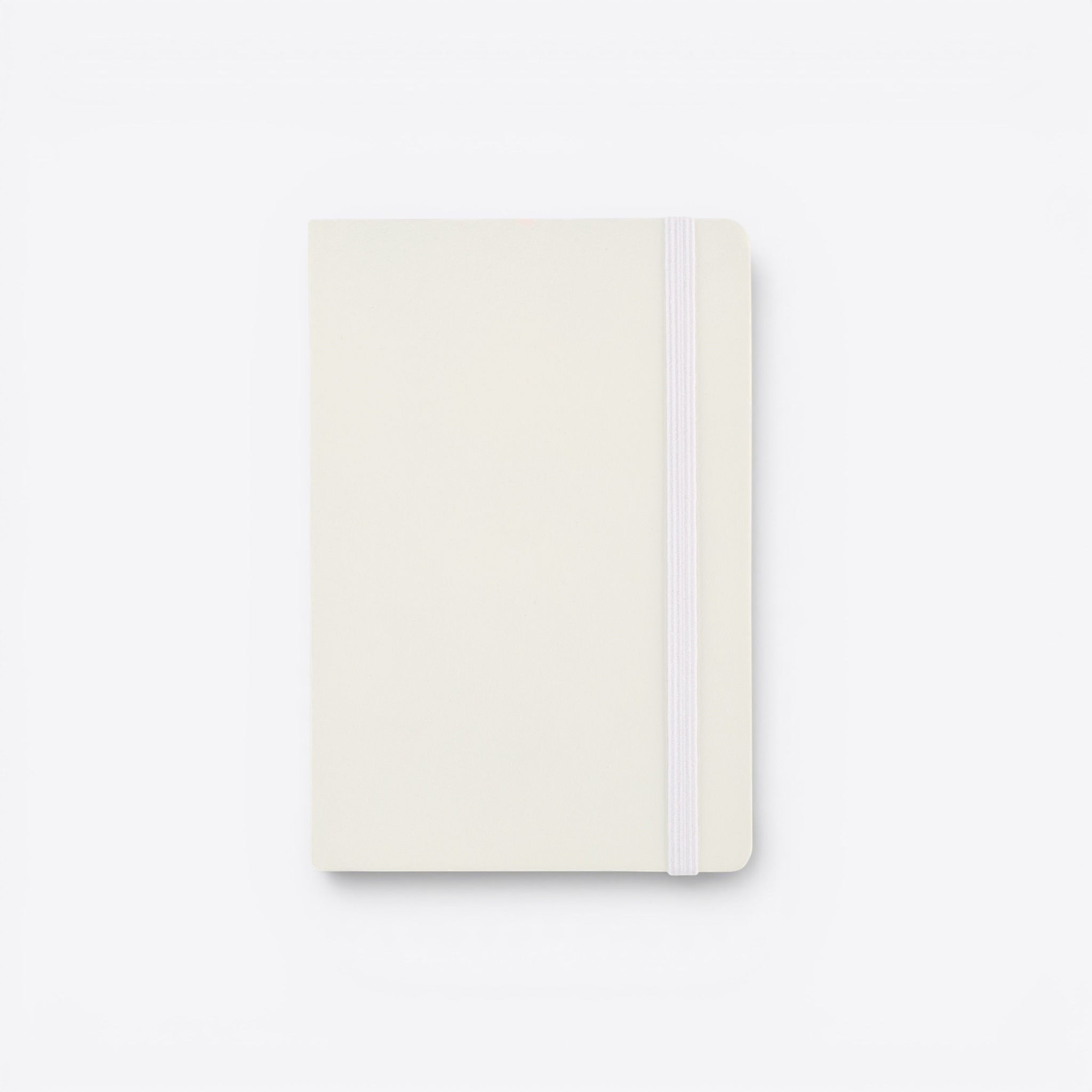 TODAY MERCH cream-colored notebook with integrated pen holder and elastic closure band.