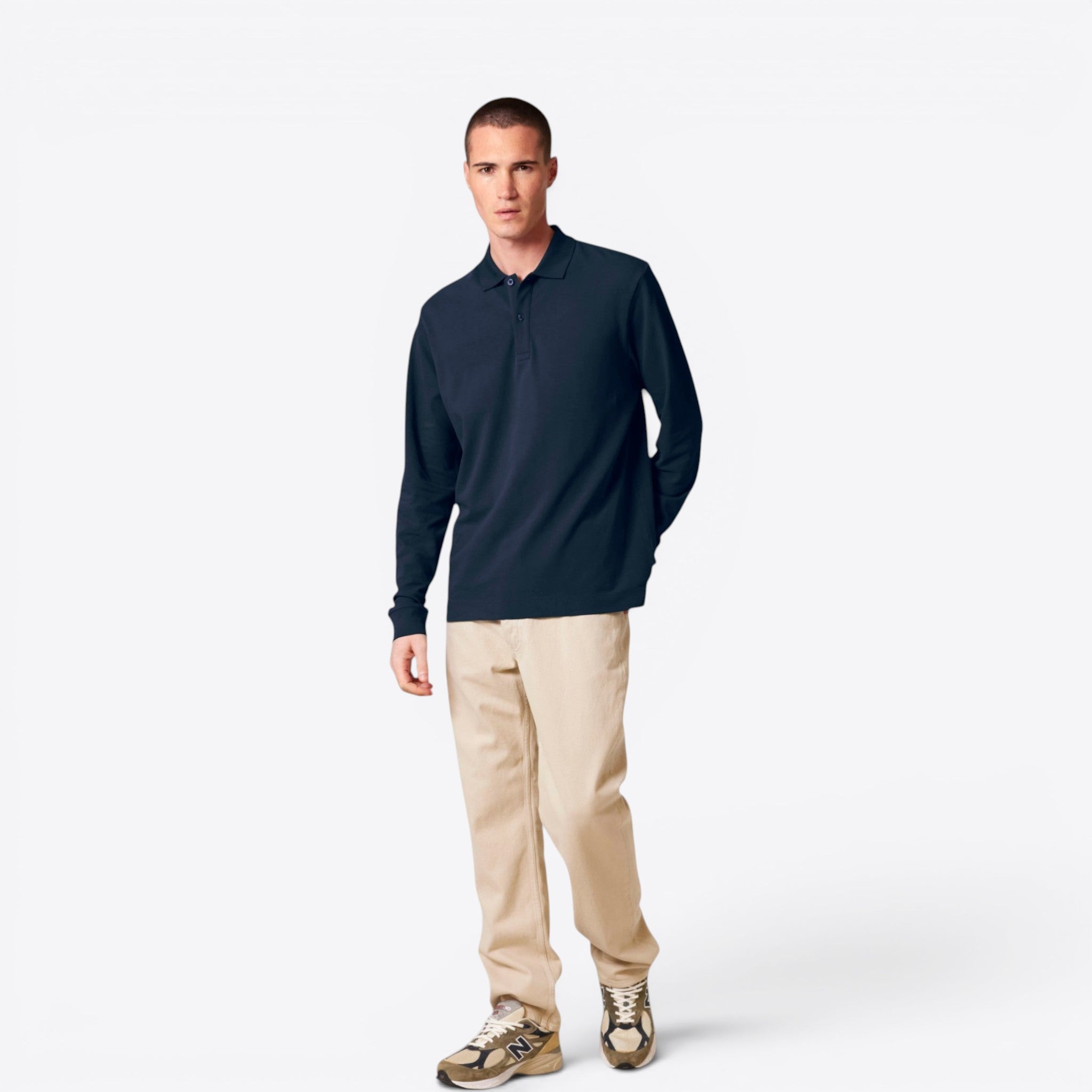 TODAY MERCH navy blue long-sleeve organic cotton polo shirt worn by a man with beige trousers.