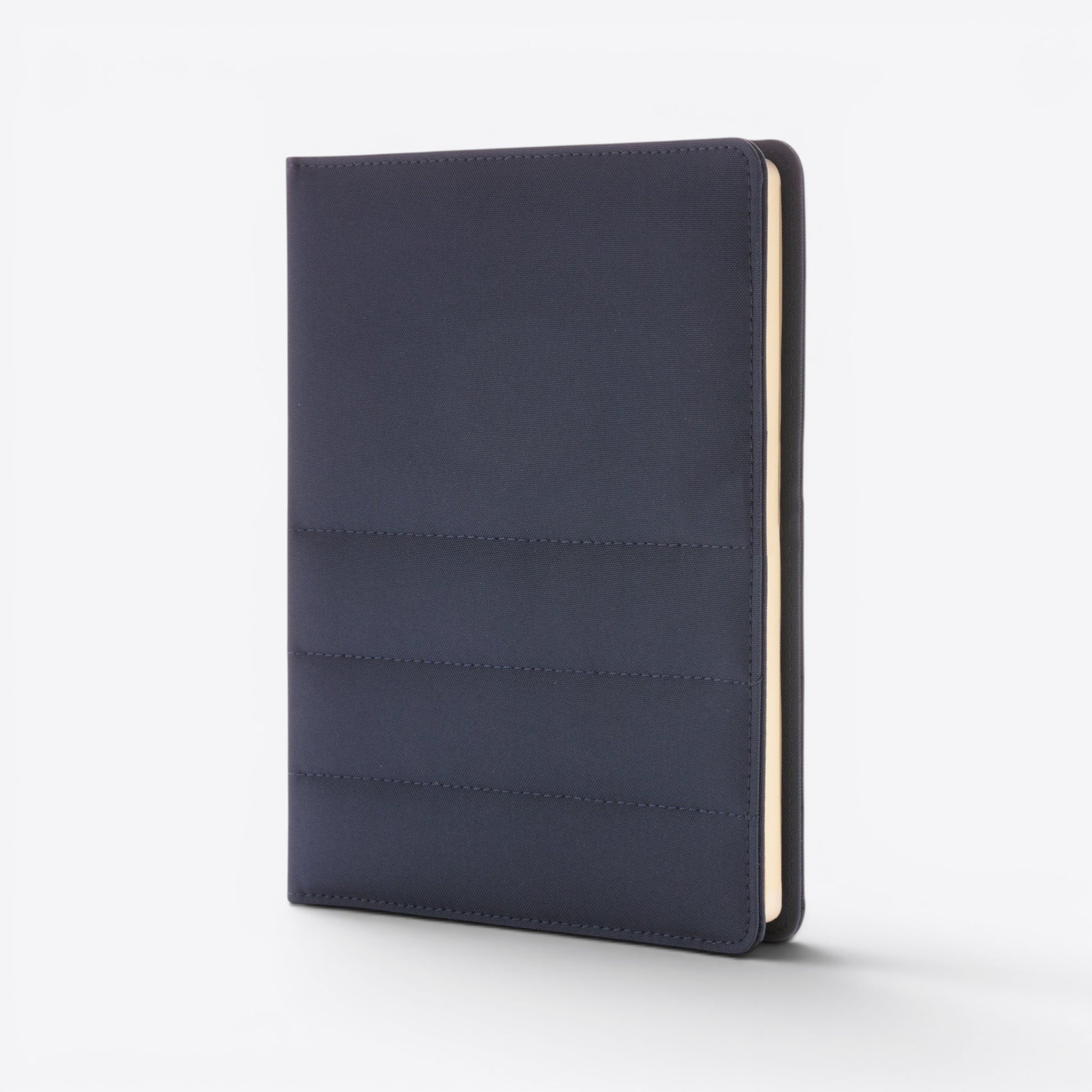 TODAY MERCH navy blue quilted document holder with stitched detailing and cream-colored pages visible on the side.