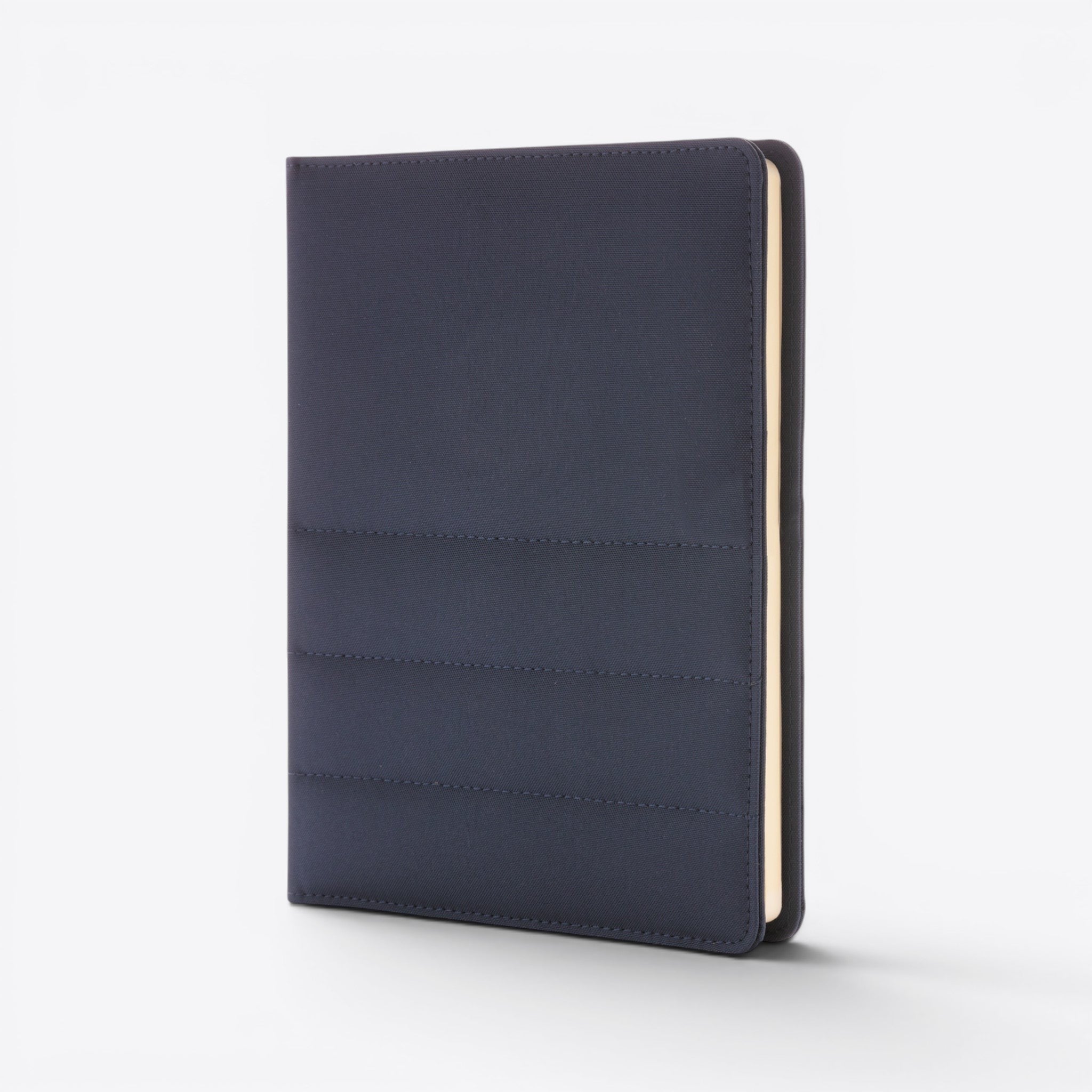 TODAY MERCH navy blue quilted document holder with stitched detailing and cream-colored pages visible on the side.