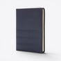 TODAY MERCH navy blue quilted document holder with stitched detailing and cream-colored pages visible on the side. - Navy